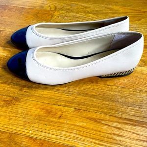 Nude and black cap toe ballet flat.